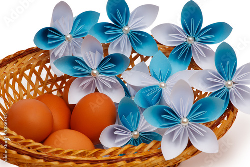 Paper flower with eggs in a basket