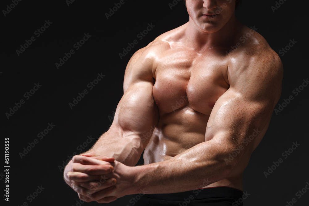 Cropped picture of muscle man posing in studio Cropped picture of muscle man posing in studio