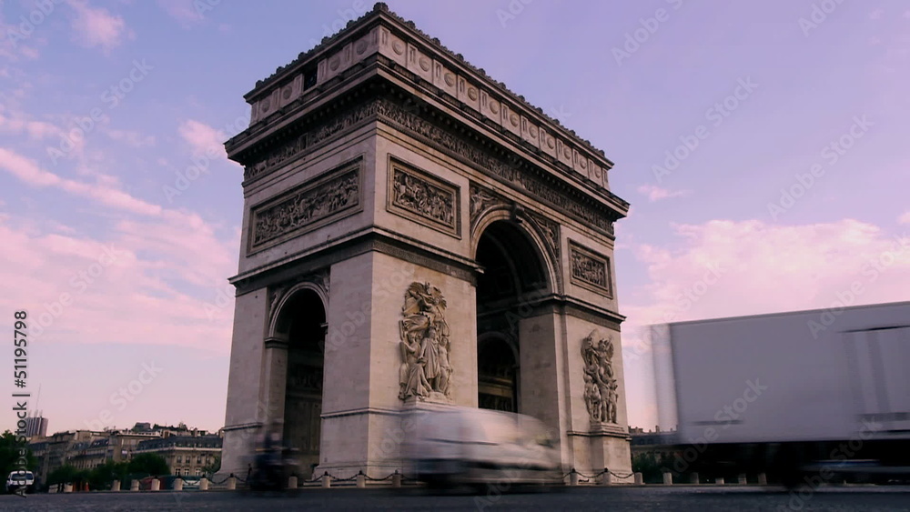 cars drive past arc de triomph