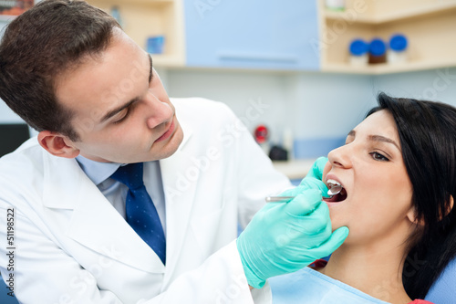 dentist is treating teeth of the patient