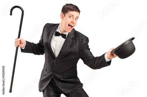 A young performer with cane and retro hat gesturing