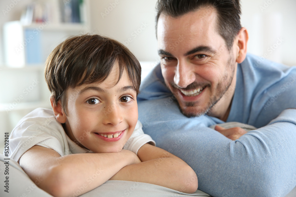Portrait of father and son relaxing at home Portrait of father and son relaxing at home
