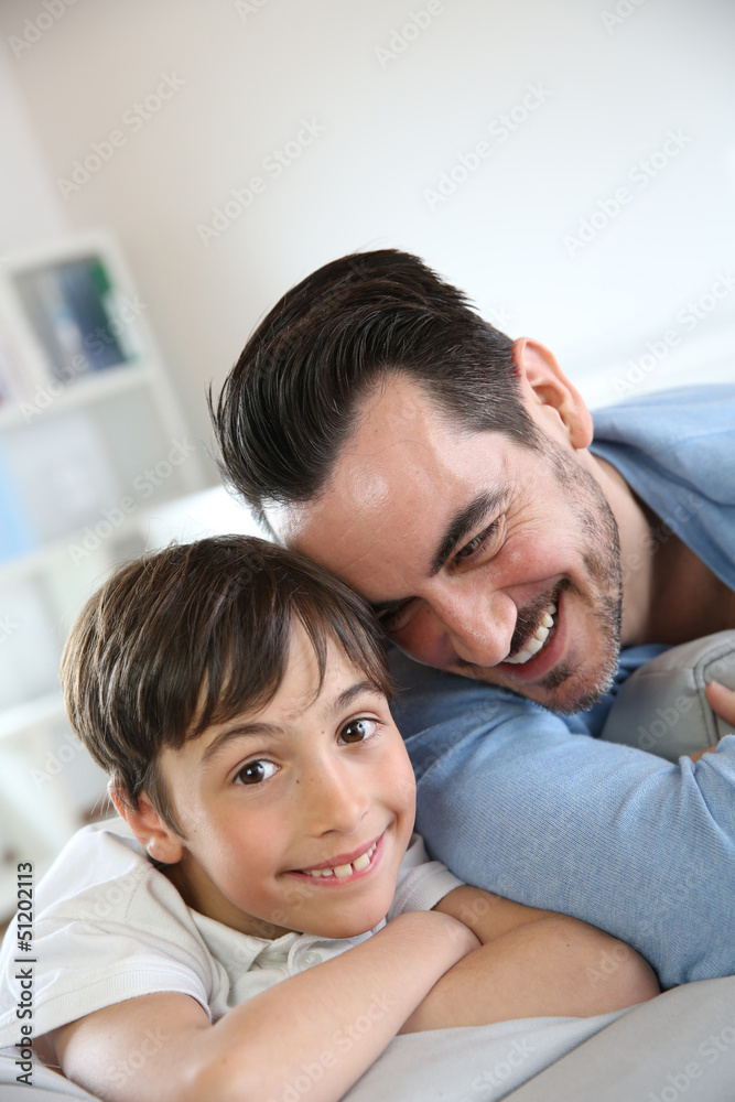 Portrait of father and son relaxing at home Portrait of father and son relaxing at home