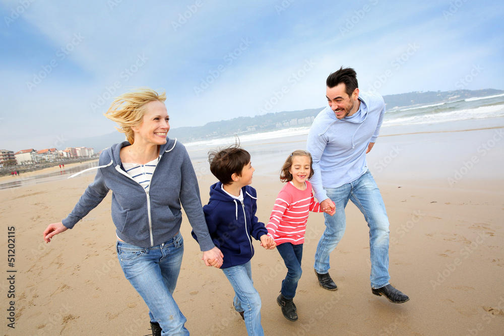 Family running on the beach Family running on the beach