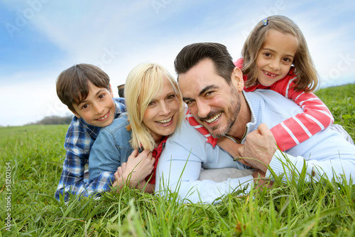 Family of four relaxing in countryside