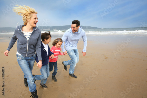 Family running on the beach