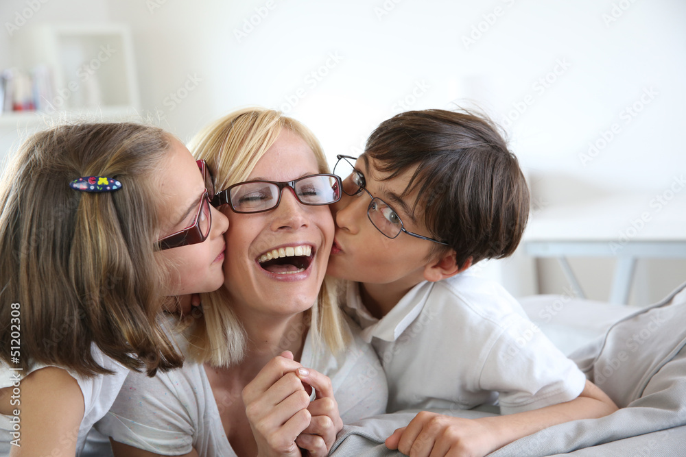 Portrait of children kissing her mom Portrait of children kissing her mom