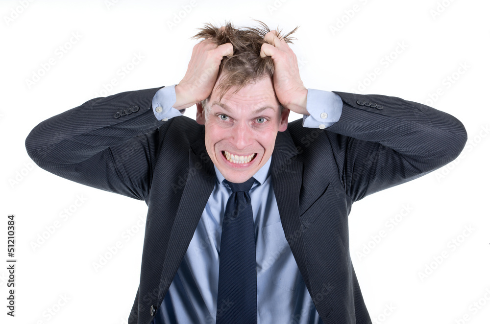 Stressed or desperate businessman pulling his hair out