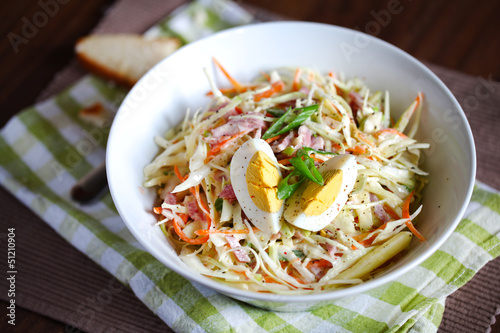 Light coleslaw salad with hard boiled egg, scallions and apples