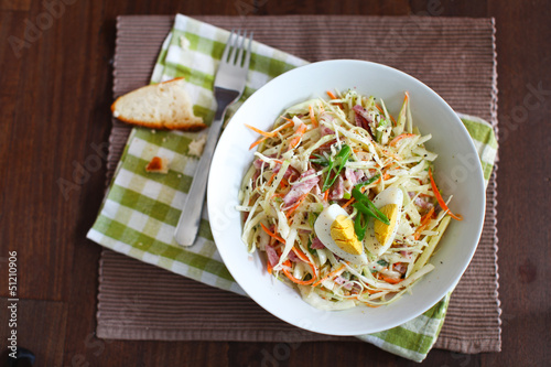 Coleslaw salad with apples, ham and hard boiled egg
