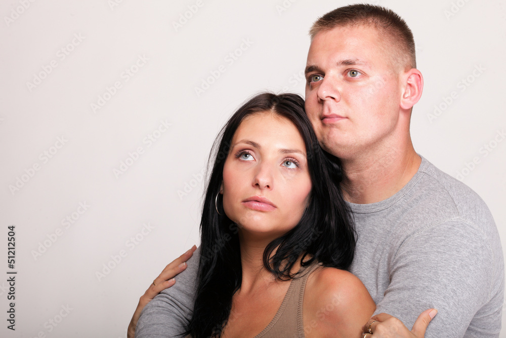 Beautiful pensive man woman stand near gray wal Beautiful pensive man woman stand near gray wal