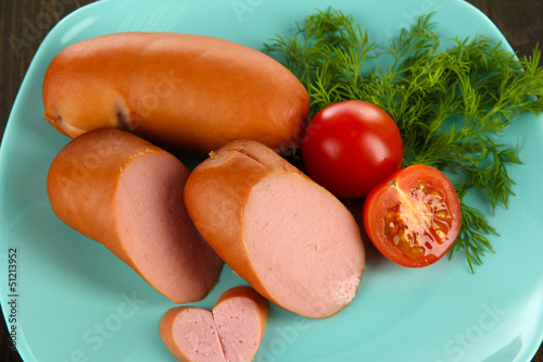 Sausage, greens, tomato on plate