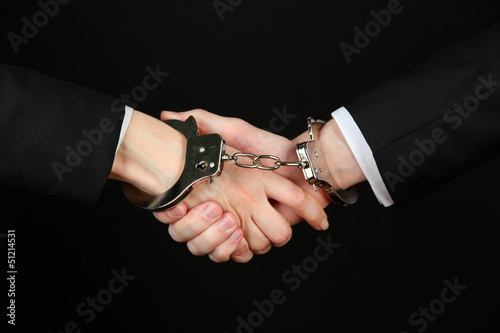 Man and woman hands and breaking handcuffs isolated