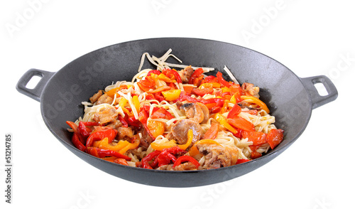 Noodles with vegetables on wok isolated on white