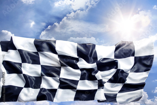 Checkered flag in bright sky