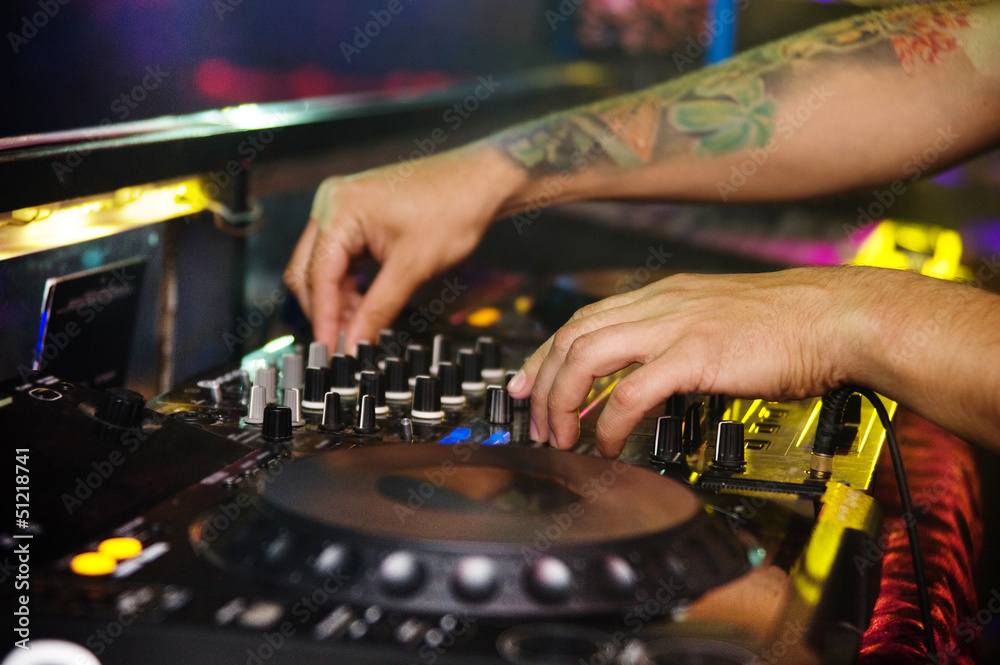 Dj mixes the track in the nightclub at a party Dj mixes the track in the nightclub at a party
