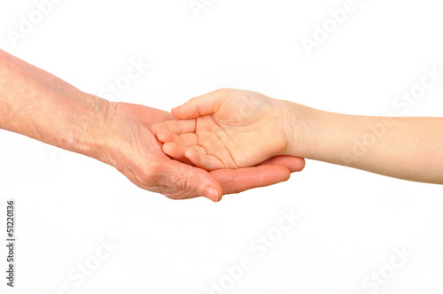A child puts his hand into the palm of an old woman