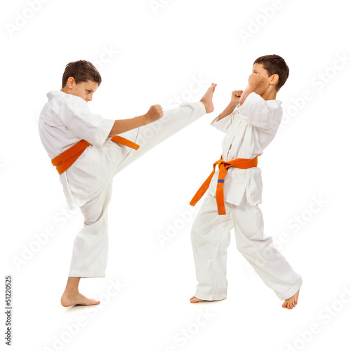 Two boys in white kimono fighting