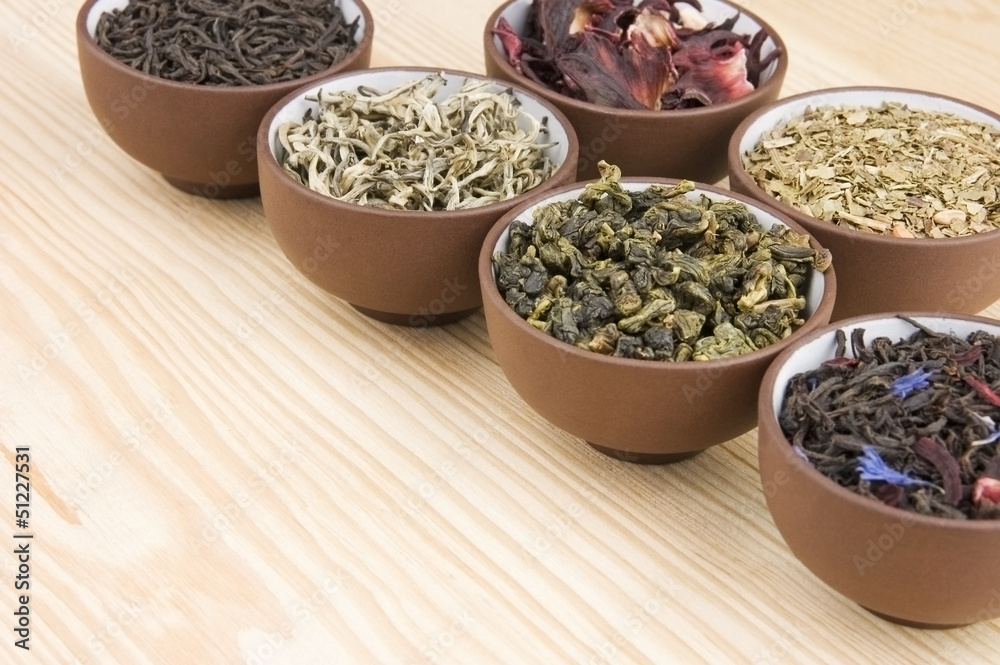 Assortment of dry tea in ceramic bowls Assortment of dry tea in ceramic bowls