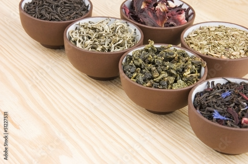 Assortment of dry tea in ceramic bowls