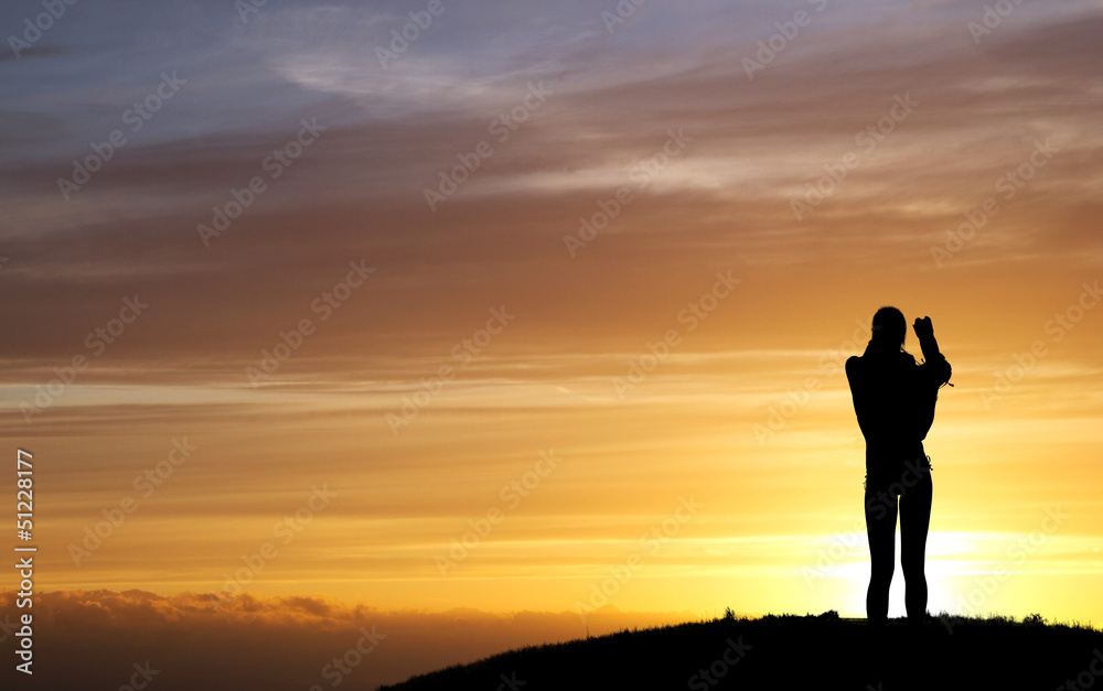 silhouette of female photographer in sunset