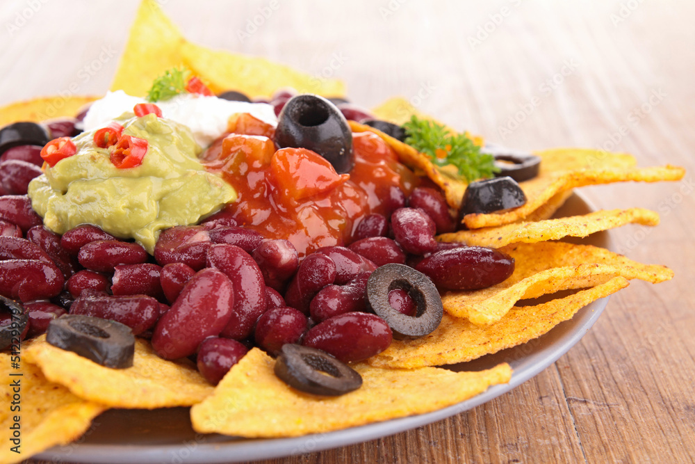 plate of nachos with guacamole plate of nachos with guacamole