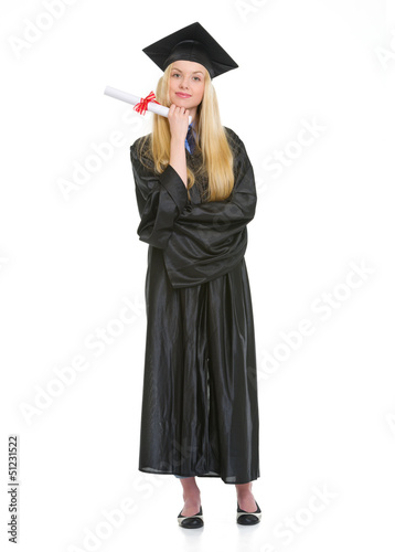 Full length portrait of woman in graduation gown with diploma