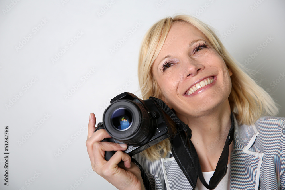 Cheerful woman photographer holding camera Cheerful woman photographer holding camera