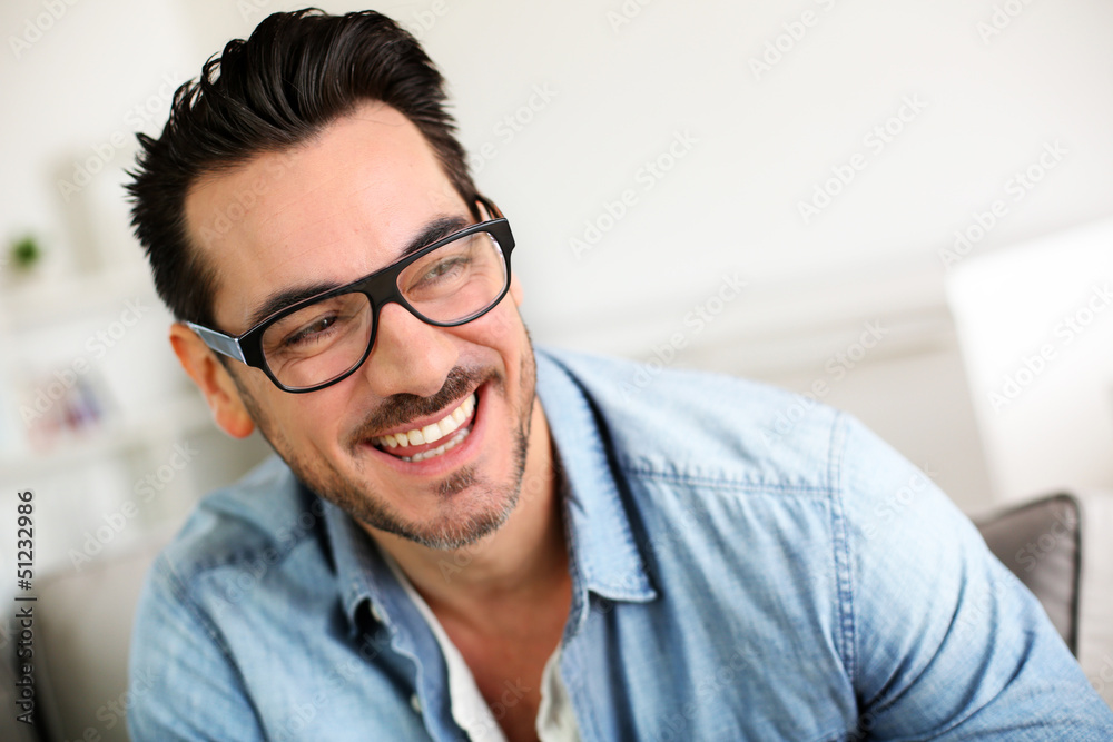 Cheerful trendy guy with black eyeglasses on Cheerful trendy guy with black eyeglasses on