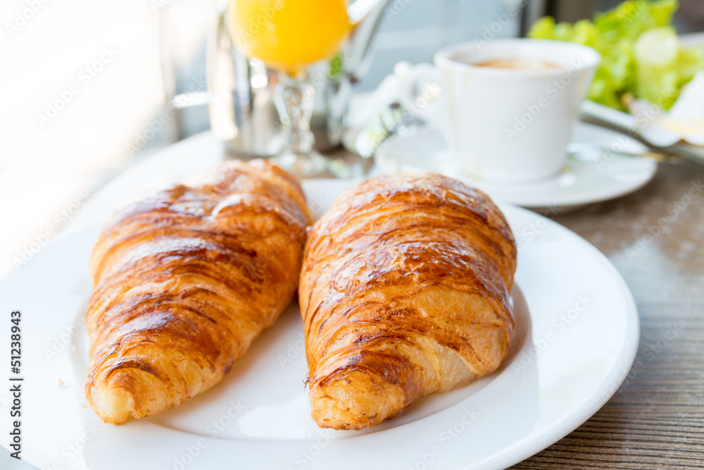 Breakfast with coffee and croissants