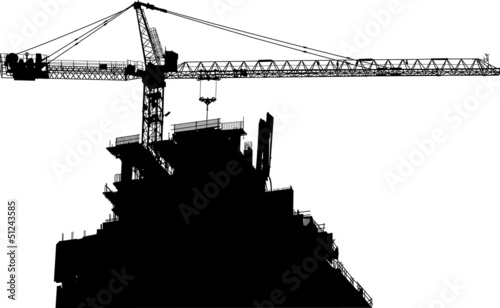Silhouettes of crane on building