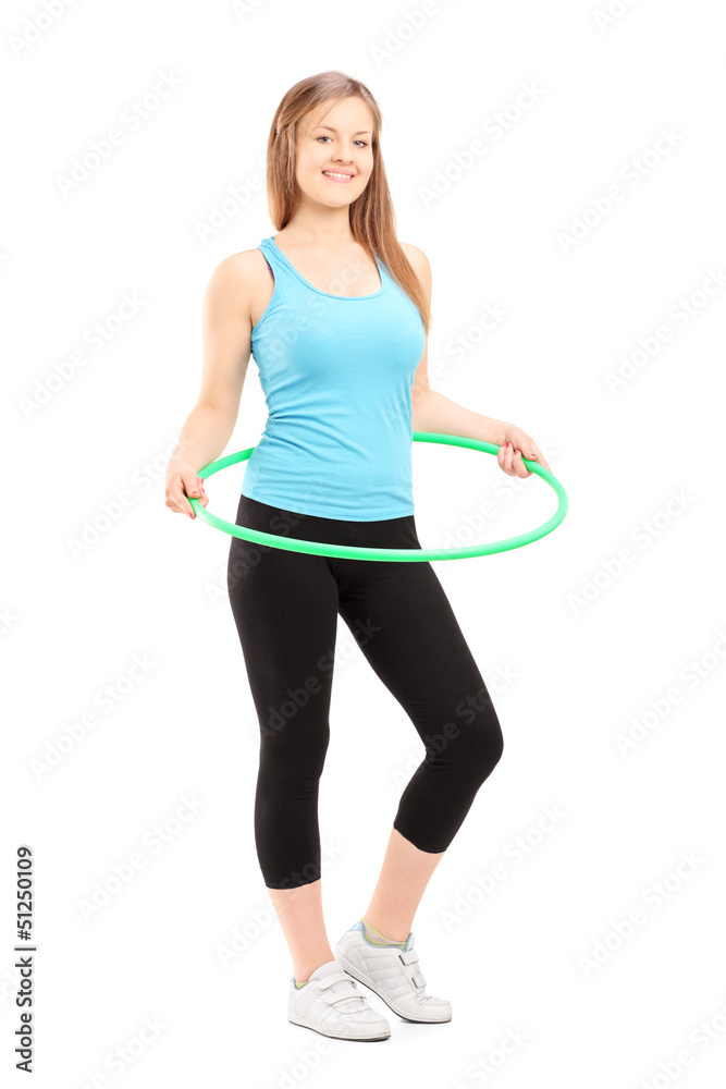 Full length potrait of a young female athlete exercising with a Full length potrait of a young female athlete exercising with a