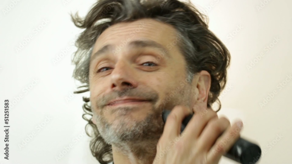 man with electric razor over white man with electric razor over white