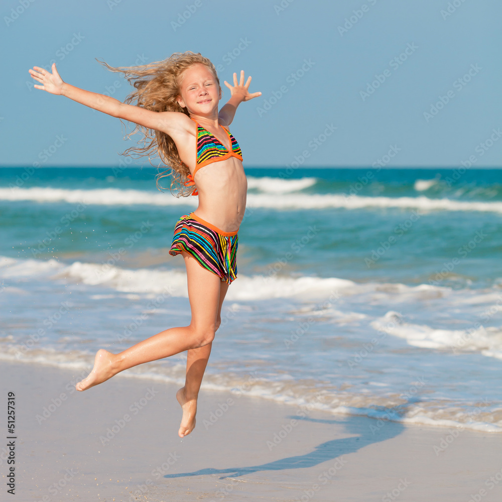 flying jump beach girl on blue sea shore in summer vacation