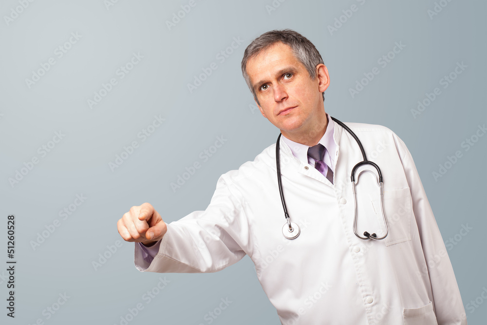 Middle aged doctor gesturing with copy space Middle aged doctor gesturing with copy space