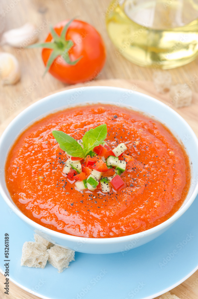 cold tomato soup gazpacho with basil in a bowl, top view cold tomato soup gazpacho with basil in a bowl, top view