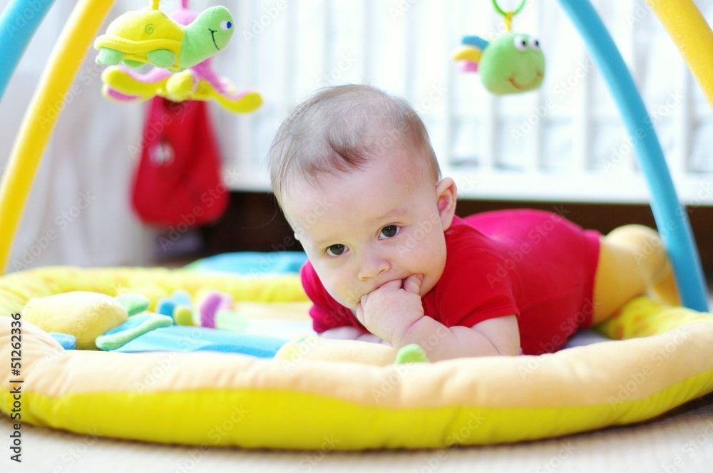 Sad baby on playmat Stock Photo Adobe Stock