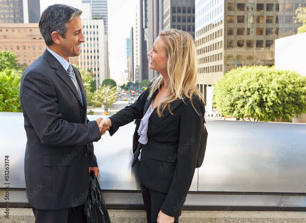 Businessman And Businesswoman Shaking Hands In Street Businessman And Businesswoman Shaking Hands In Street