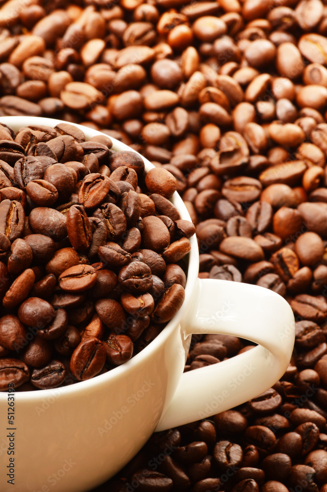 Naklejka premium Composition with white cup and coffee beans