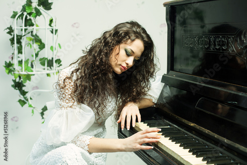 Romantic girl playing piano photo