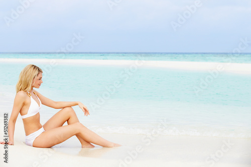 Woman Sunbathing On Beautiful Beach Holiday © Monkey Business