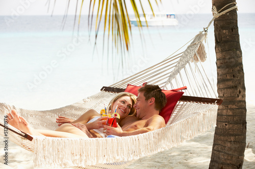 Romantic Couple Relaxing In Beach Hammock