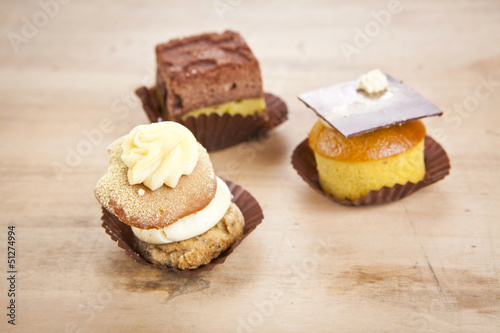 delicious cupcake pastry on wooden background table