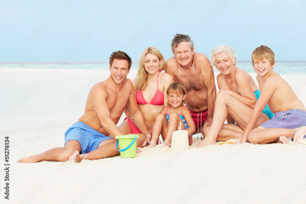 Multi Generation Family Having Fun On Beach Holiday Multi Generation Family Having Fun On Beach Holiday