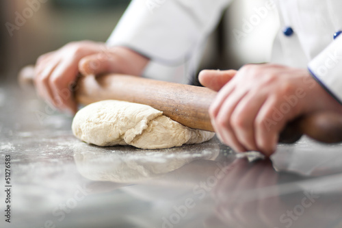 Chef preparing dough in a kitchen