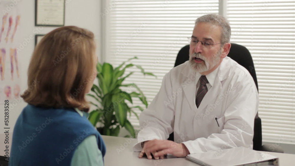 Doctor speaking with female patient in office Doctor speaking with female patient in office