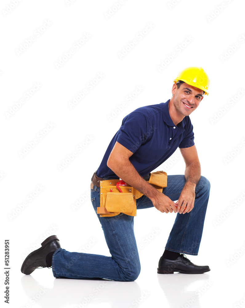 handyman kneeling over white background handyman kneeling over white background