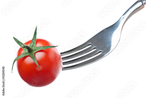 one cherry tomato on a fork over white background