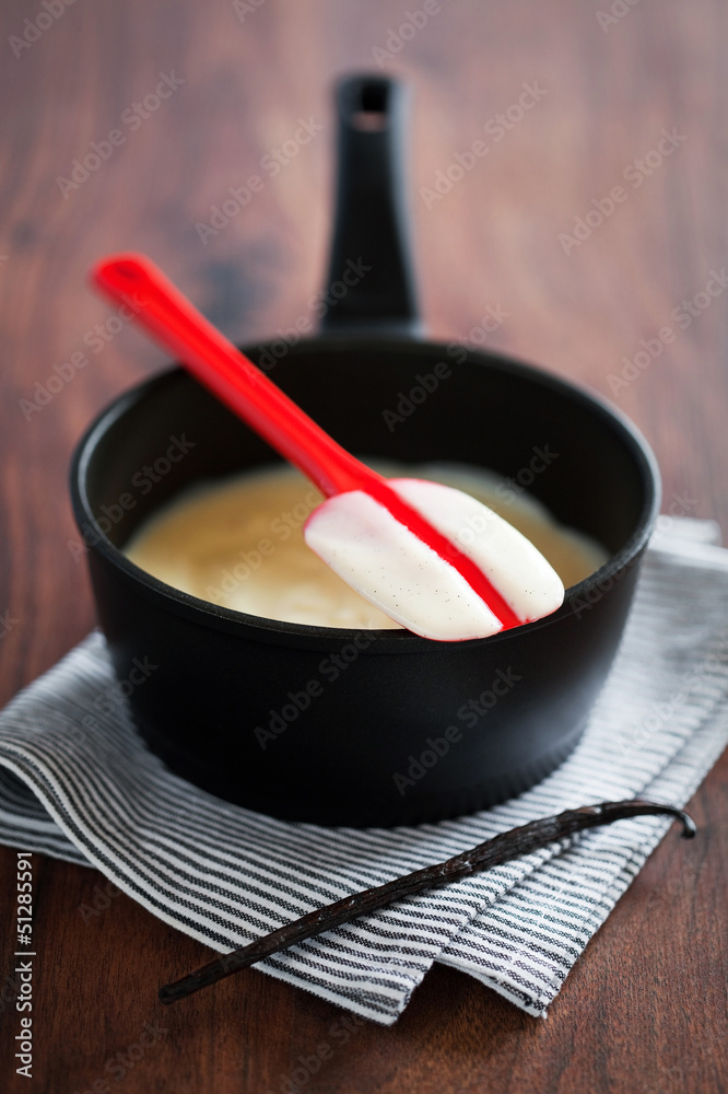Making fresh vanilla custard in a metal pan, selective focus Making fresh vanilla custard in a metal pan, selective focus