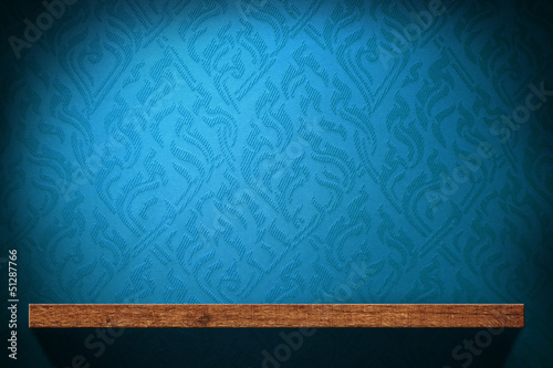 Blank Wood shelf with blue retro wallpaper background